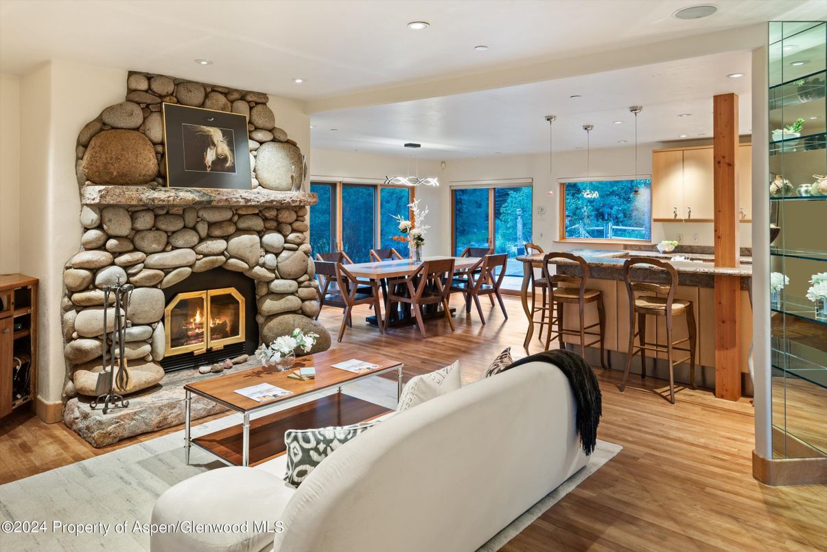 Dining room, Fireplace, Interior, Living room, Pendant Lights, Recessed Lighting, Stone Walls, Wood Texture Flooring