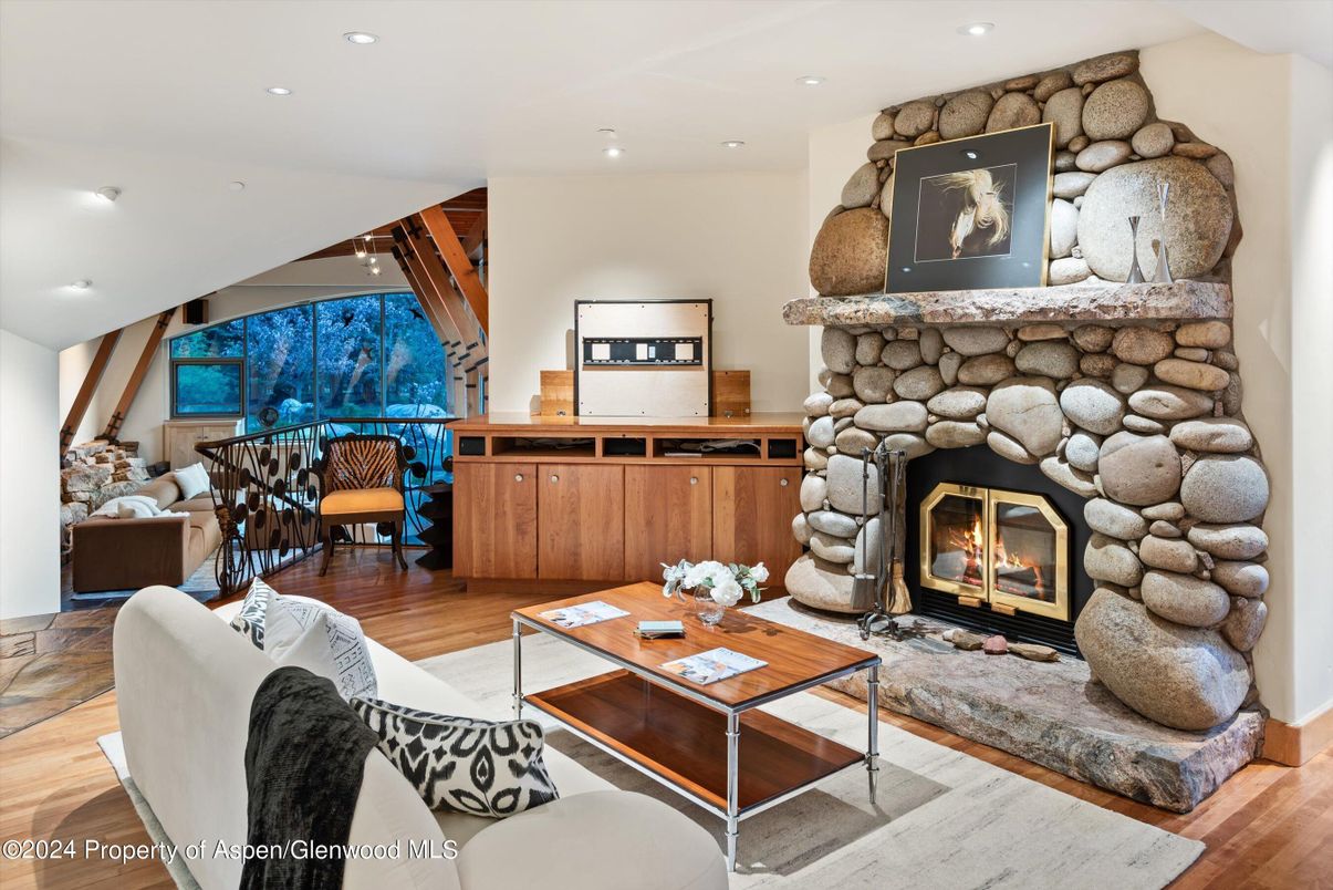 Fireplace, Interior, Living room, Recessed Lighting, Stone Walls, Wood Texture Flooring