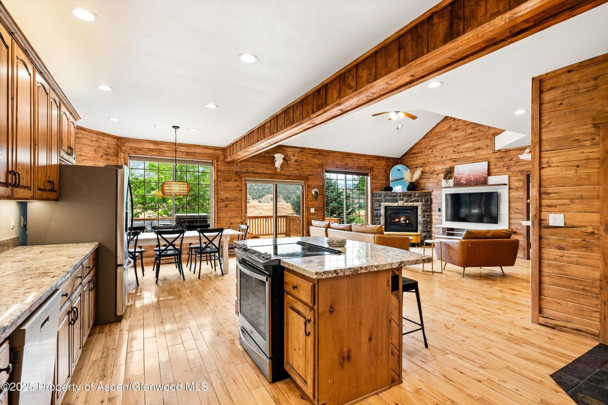 Dining room, Fireplace, Interior, Kitchen, Living room, Pendant Lights, Recessed Lighting, Stone Walls, Wood Texture Flooring, Wooden Walls