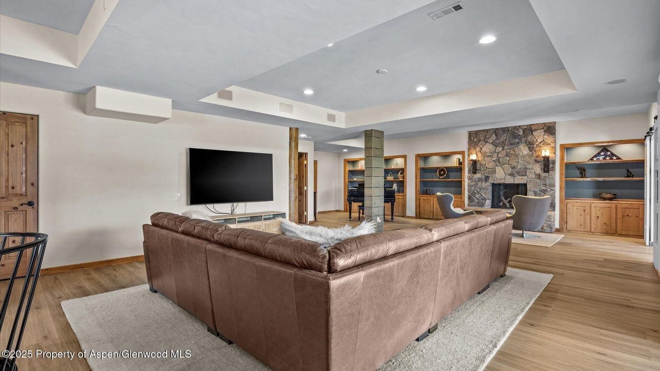 Fireplace, Interior, Living room, Recessed Lighting, Stone Walls, Wood Texture Flooring