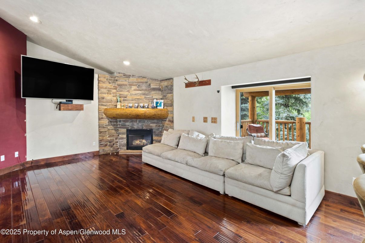 Fireplace, Interior, Living room, Recessed Lighting, Stone Walls, Wood Texture Flooring