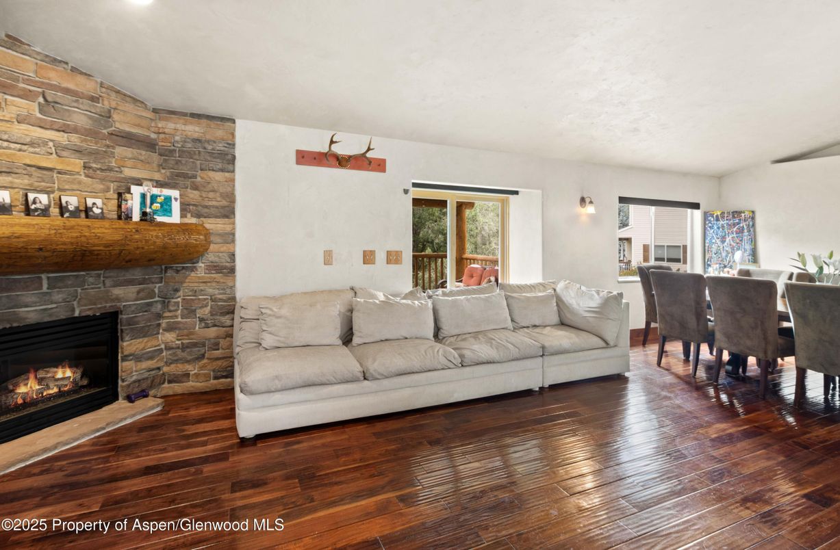 Dining room, Fireplace, Interior, Living room, Recessed Lighting, Stone Walls, Wood Texture Flooring
