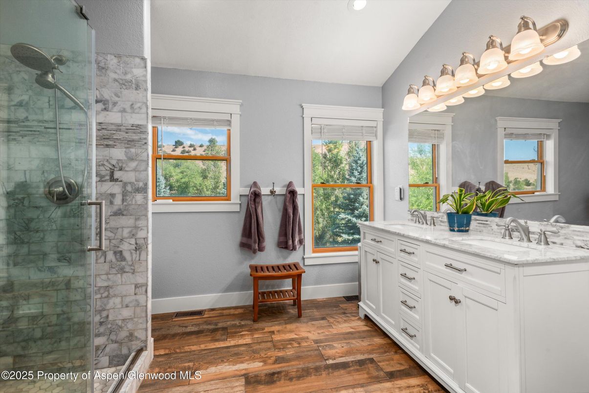 Bathroom, Dual Sink Vanities, Glass Shower, Interior, Marble Walls, Recessed Lighting, Wood Texture Flooring