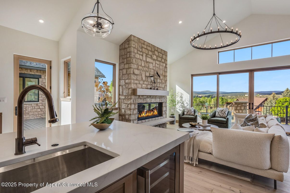 Fireplace, Interior, Kitchen, Living room, Pendant Lights, Recessed Lighting, Stone Walls, Water, Wood Texture Flooring
