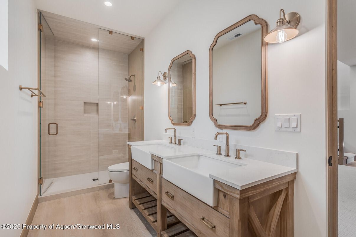Bathroom, Dual Sink Vanities, Glass Shower, Interior, Recessed Lighting, Wood Texture Flooring