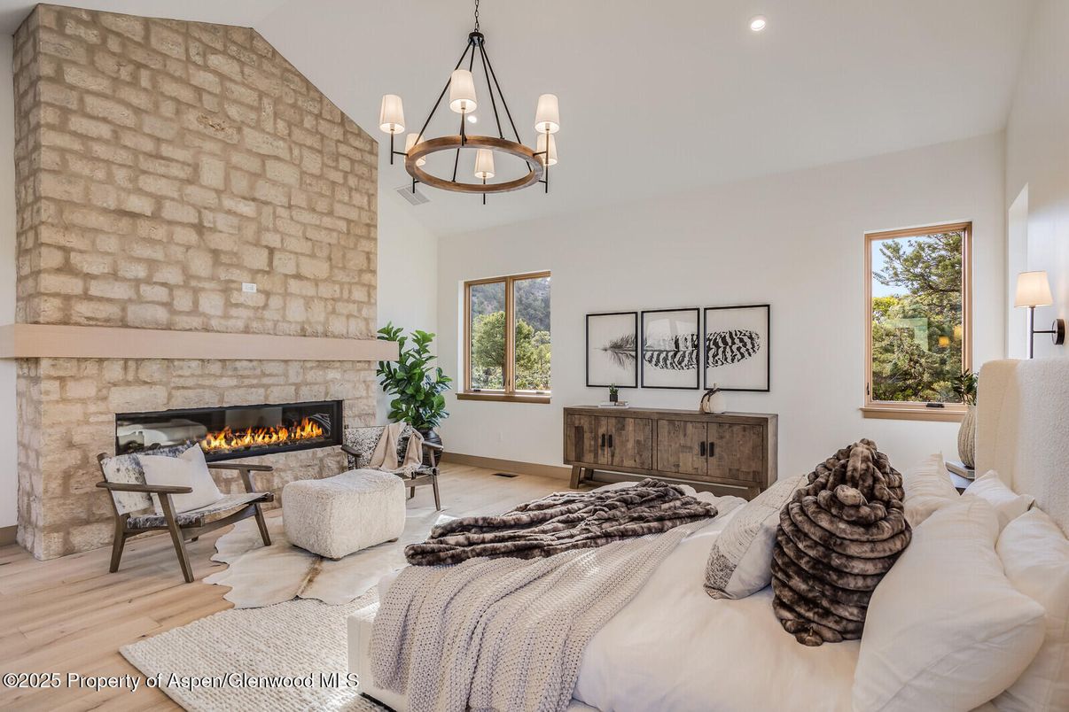 Bedroom, Chandelier, Fireplace, Interior, Living room, Pendant Lights, Recessed Lighting, Stone Walls, Wood Texture Flooring