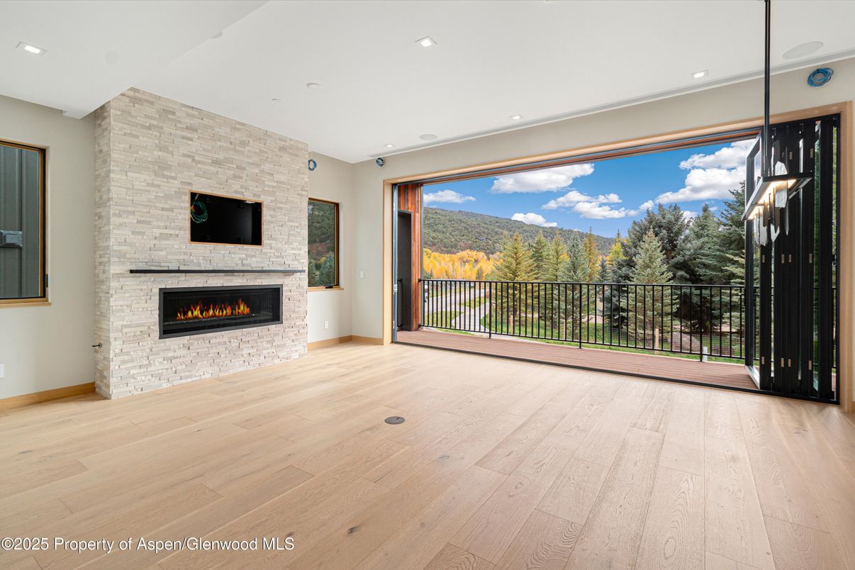 Empty room, Fireplace, Interior, Recessed Lighting, Stone Walls, Wood Texture Flooring