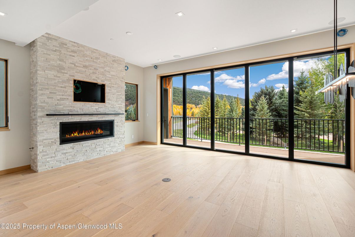 Empty room, Fireplace, Interior, Pendant Lights, Recessed Lighting, Stone Walls, Wood Texture Flooring