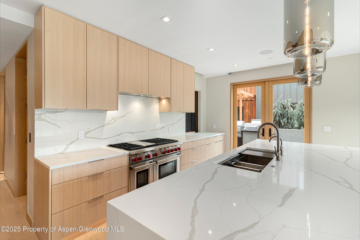 Interior, Kitchen, Marble Walls, Recessed Lighting, Stainless Steel Appliances, Wood Texture Flooring
