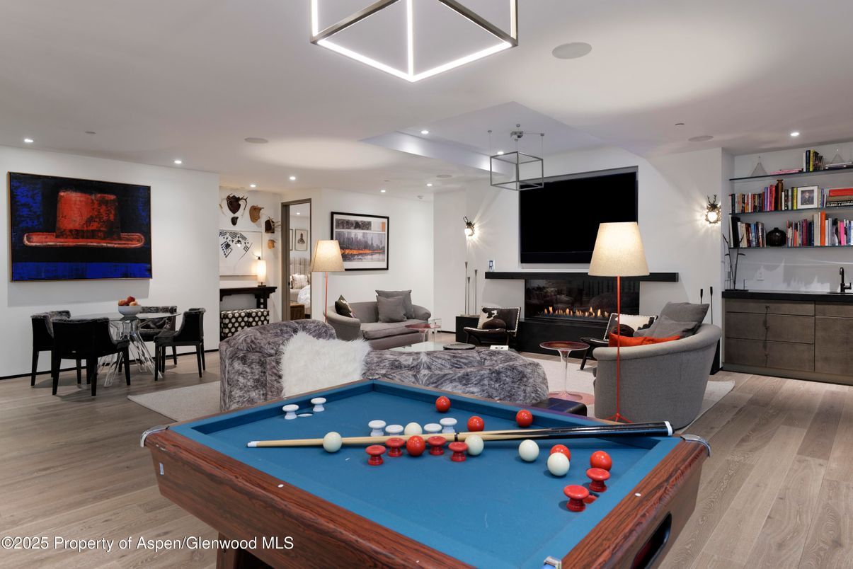 Billiard Table, Dining room, Fireplace, Game Room, Interior, Living room, Pendant Lights, Recessed Lighting, Wood Texture Flooring