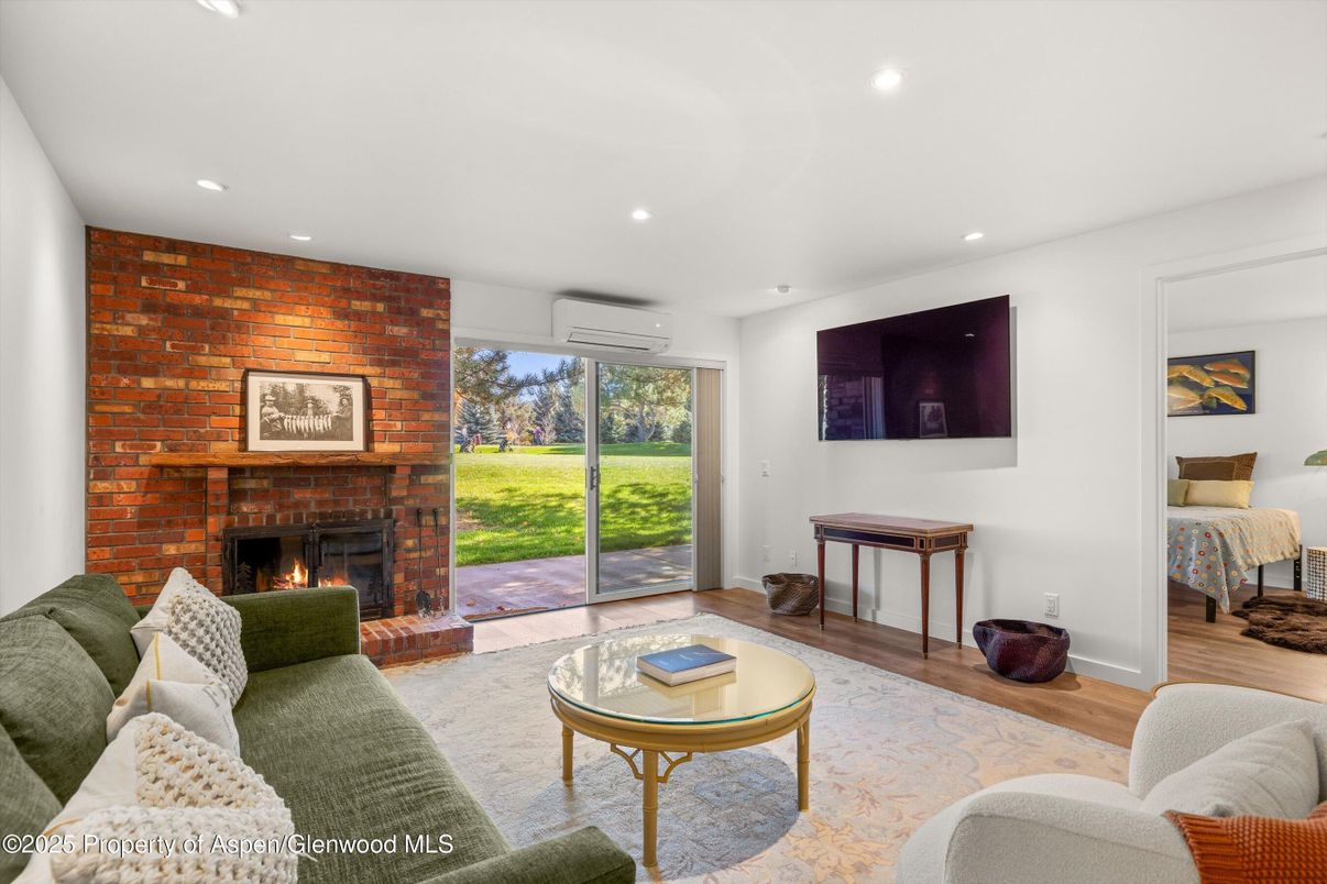 Fireplace, Interior, Living room, Recessed Lighting, Stone Walls, Wood Texture Flooring