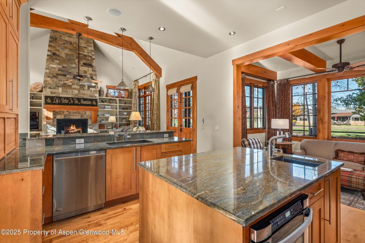 Fireplace, Interior, Kitchen, Pendant Lights, Recessed Lighting, Stainless Steel Appliances, Stone Walls, Wooden Beams, Wood Texture Flooring