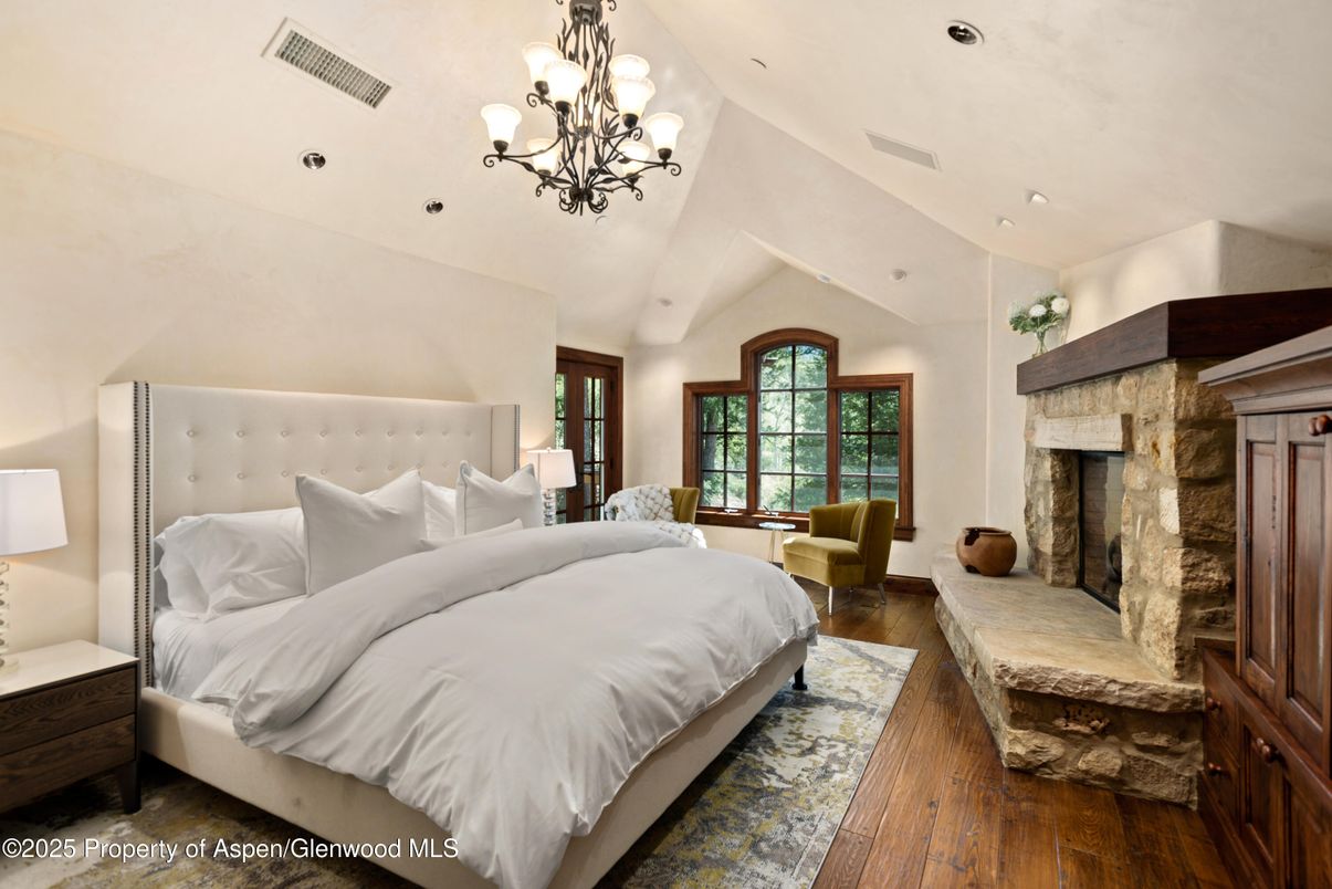 Bedroom, Chandelier, Fireplace, Interior, Recessed Lighting, Wood Texture Flooring