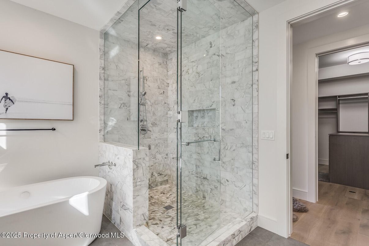 Bathroom, Free Standing Baths, Glass Shower, Interior, Marble Walls, Recessed Lighting, Wood Texture Flooring