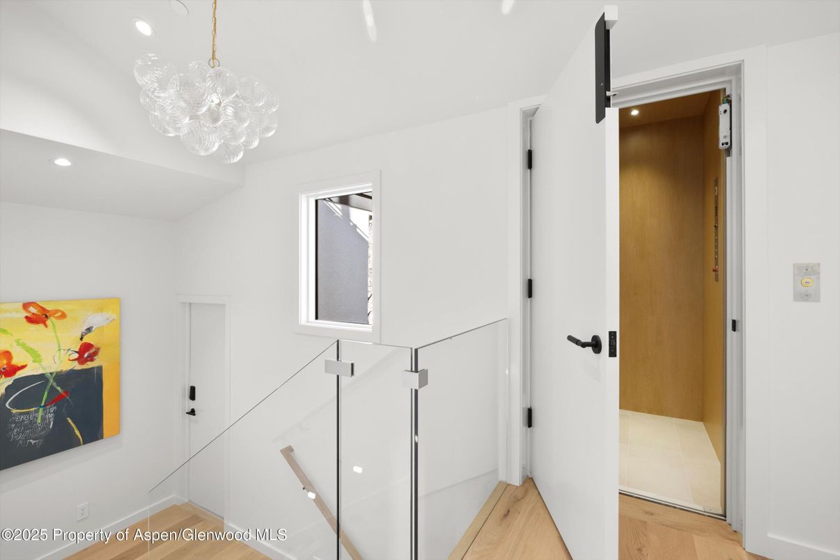 Chandelier, Elevator, Interior, Recessed Lighting, Wood Texture Flooring