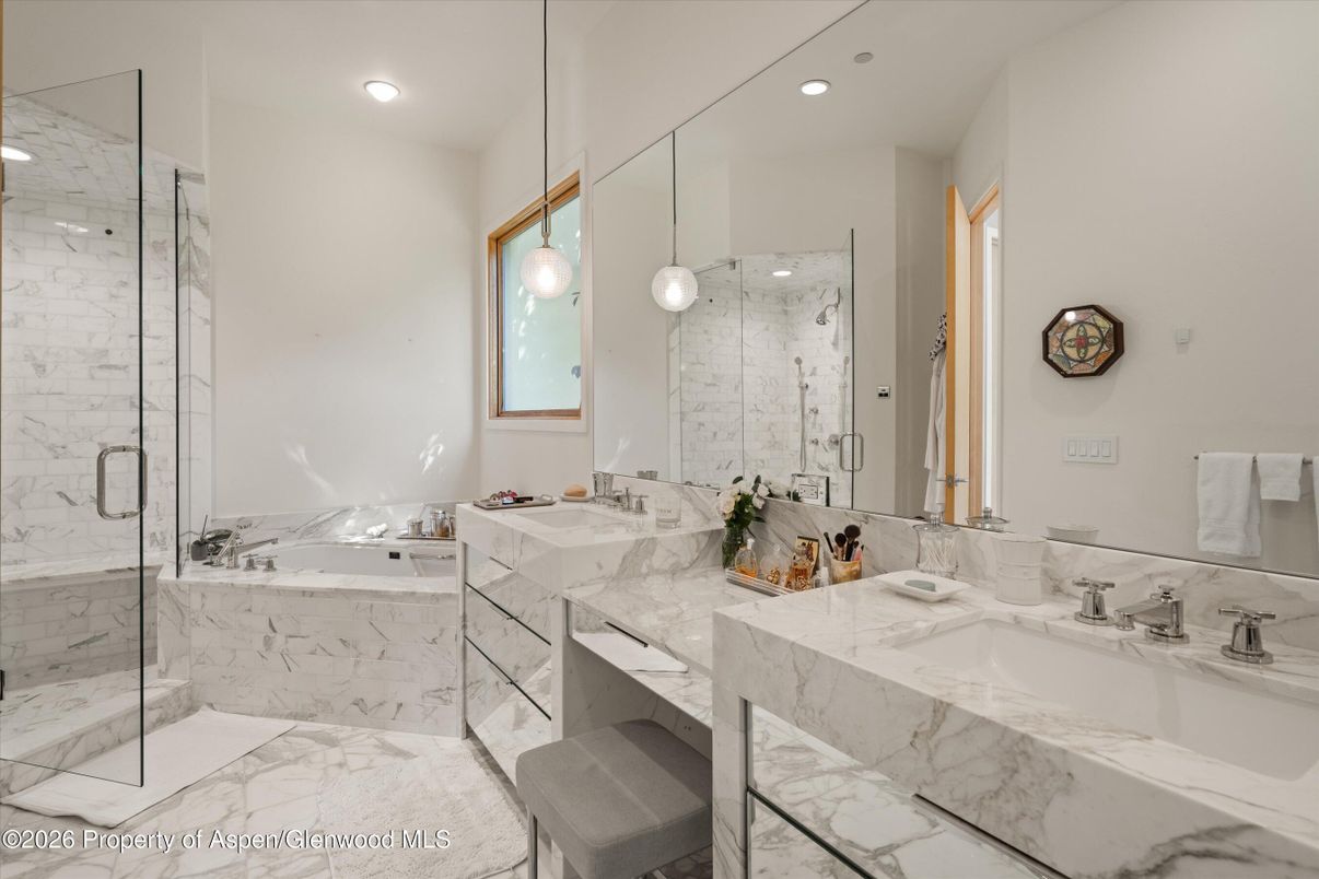 Bathroom, Dual Sink Vanities, Glass Shower, Interior, Marble, Marble Walls, Pendant Lights, Recessed Lighting