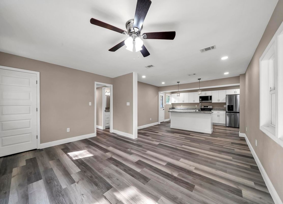 Empty room, Interior, Kitchen, Pendant Lights, Recessed Lighting, Stainless Steel Appliances, Wood Texture Flooring