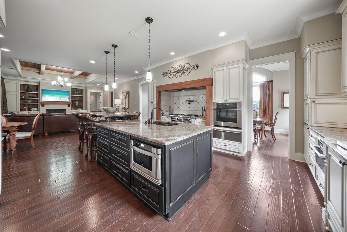 Chandelier, Dining room, Fireplace, Interior, Kitchen, Living room, Pendant Lights, Recessed Lighting, Stainless Steel Appliances, Wood Texture Flooring