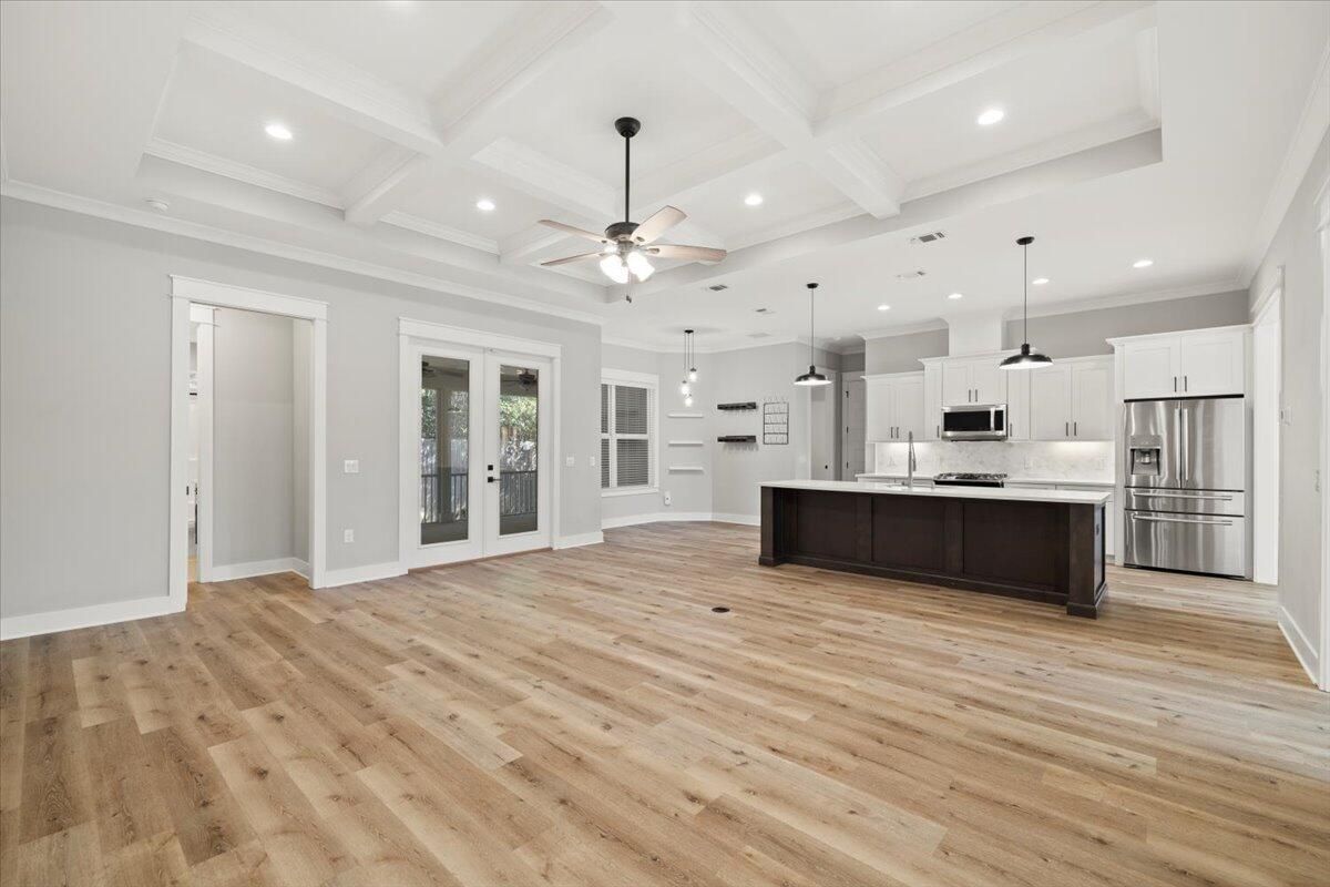 Empty room, Interior, Kitchen, Pendant Lights, Recessed Lighting, Stainless Steel Appliances, Wood Texture Flooring