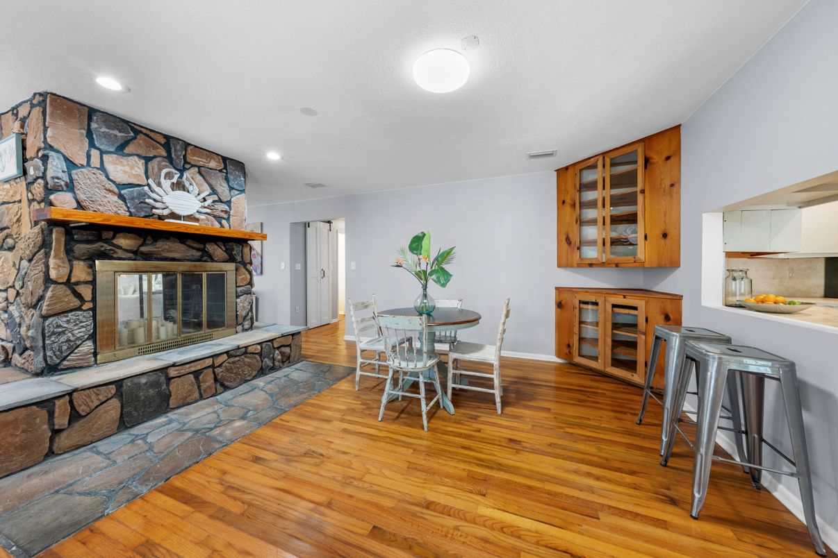 Dining room, Fireplace, Interior, Recessed Lighting, Stone Walls, Wood Texture Flooring
