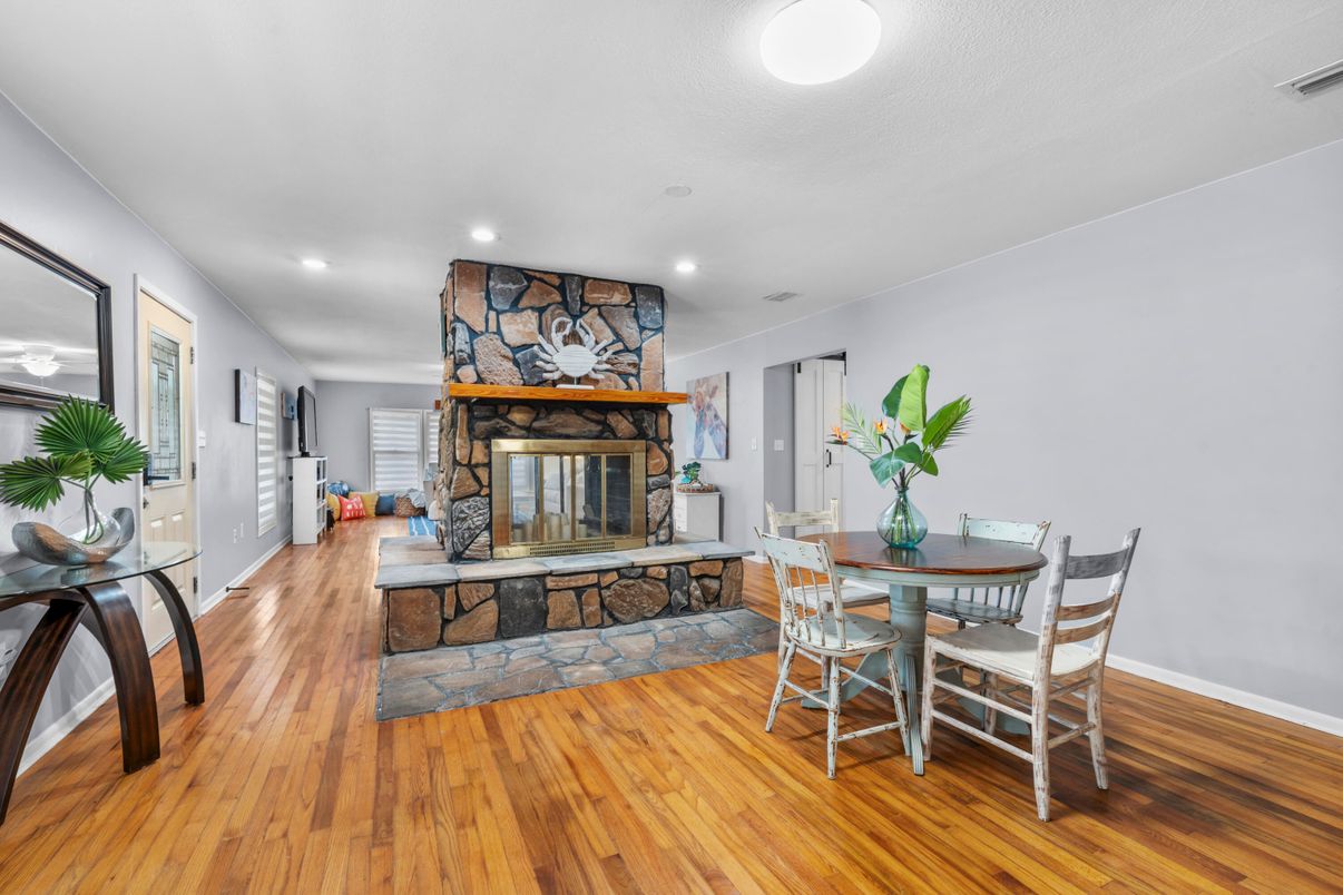 Dining room, Fireplace, Interior, Recessed Lighting, Stone Walls, Wood Texture Flooring