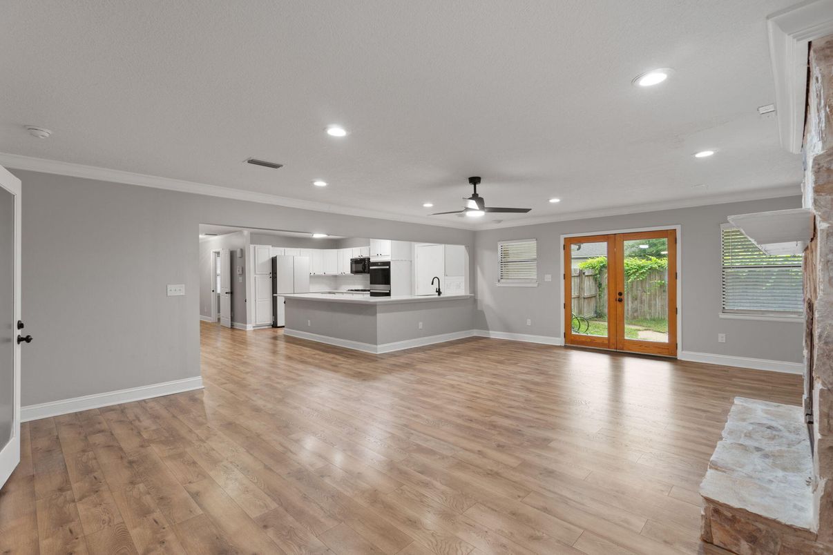 Empty room, Interior, Kitchen, Recessed Lighting, Stainless Steel Appliances, Wood Texture Flooring