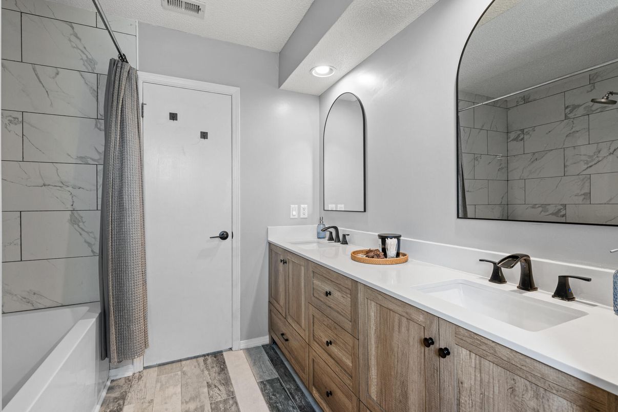 Bathroom, Dual Sink Vanities, Interior, Marble Walls, Recessed Lighting, Wood Texture Flooring