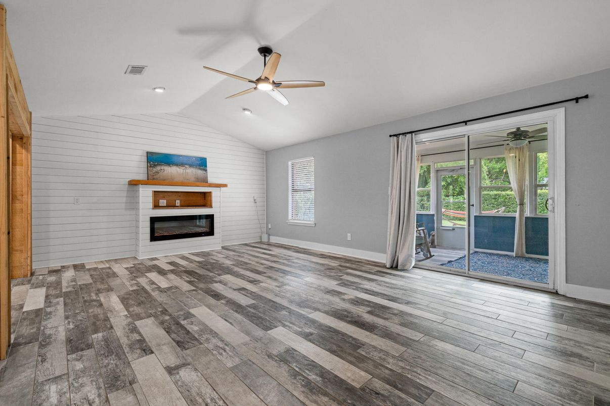 Empty room, Fireplace, Interior, Recessed Lighting, Stone Walls, Wood Texture Flooring