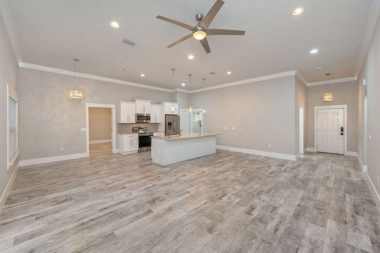 Empty room, Interior, Kitchen, Pendant Lights, Recessed Lighting, Stainless Steel Appliances, Wood Texture Flooring