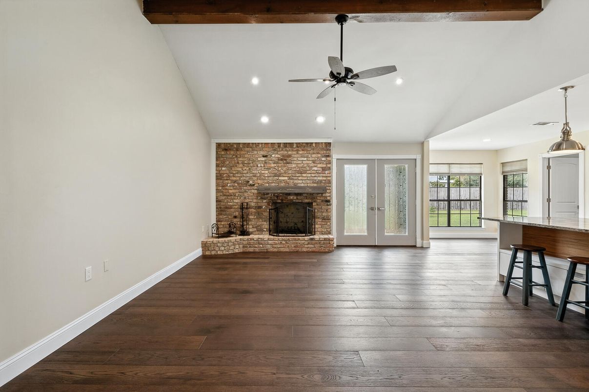 Empty room, Fireplace, Interior, Pendant Lights, Recessed Lighting, Stone Walls, Wooden Beams, Wood Texture Flooring