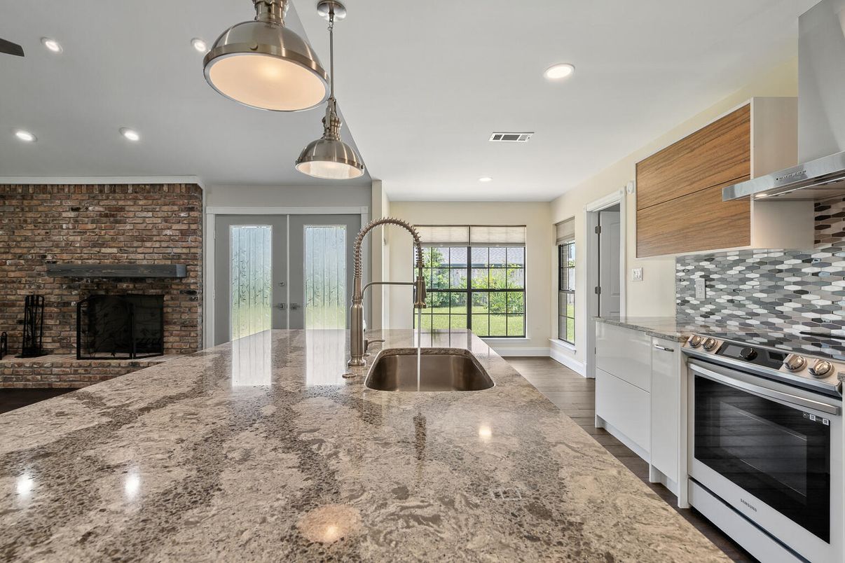 Fireplace, Interior, Kitchen, Pendant Lights, Recessed Lighting, Stainless Steel Appliances, Stone Walls, Wood Texture Flooring