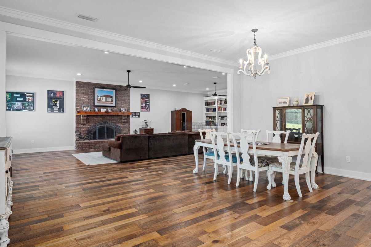 Chandelier, Dining room, Fireplace, Interior, Living room, Recessed Lighting, Stone Walls, Wood Texture Flooring