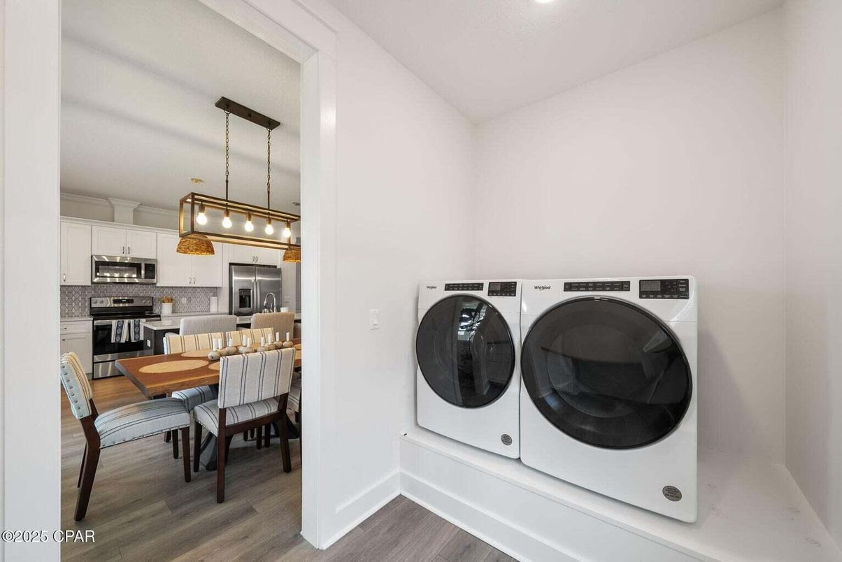 Dining room, Interior, Kitchen, Pendant Lights, Recessed Lighting, Stainless Steel Appliances, Washer, Wood Texture Flooring