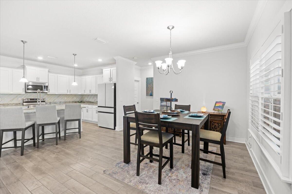Chandelier, Dining room, Interior, Kitchen, Pendant Lights, Recessed Lighting, Stainless Steel Appliances, Wood Texture Flooring