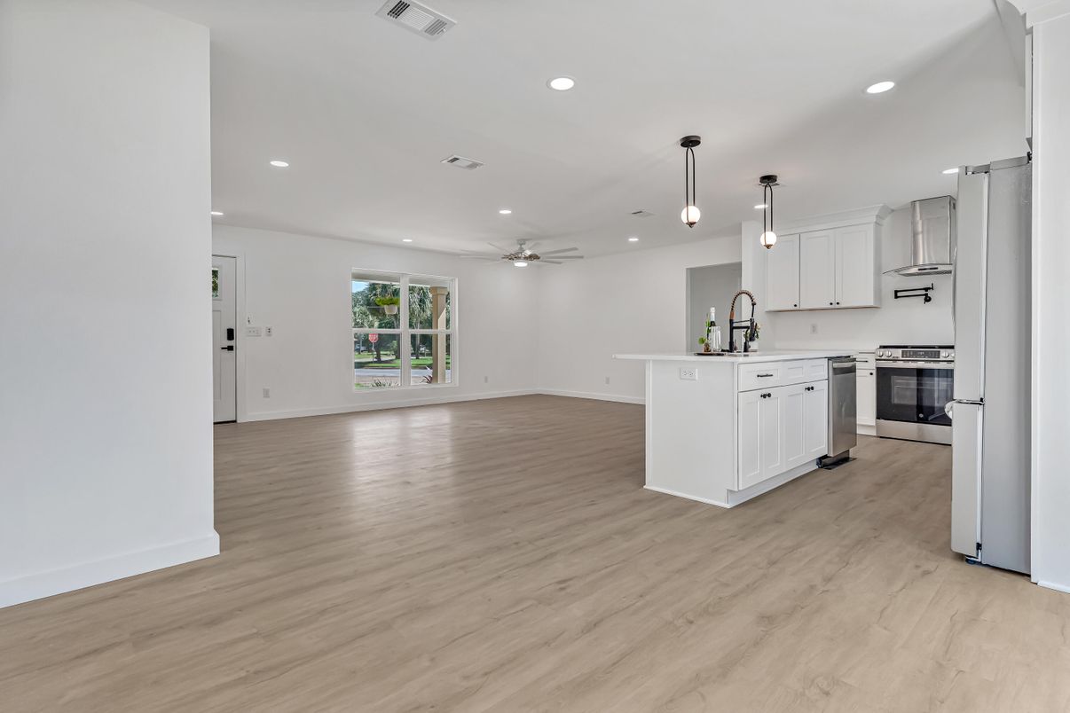 Empty room, Interior, Kitchen, Pendant Lights, Recessed Lighting, Stainless Steel Appliances, Wood Texture Flooring