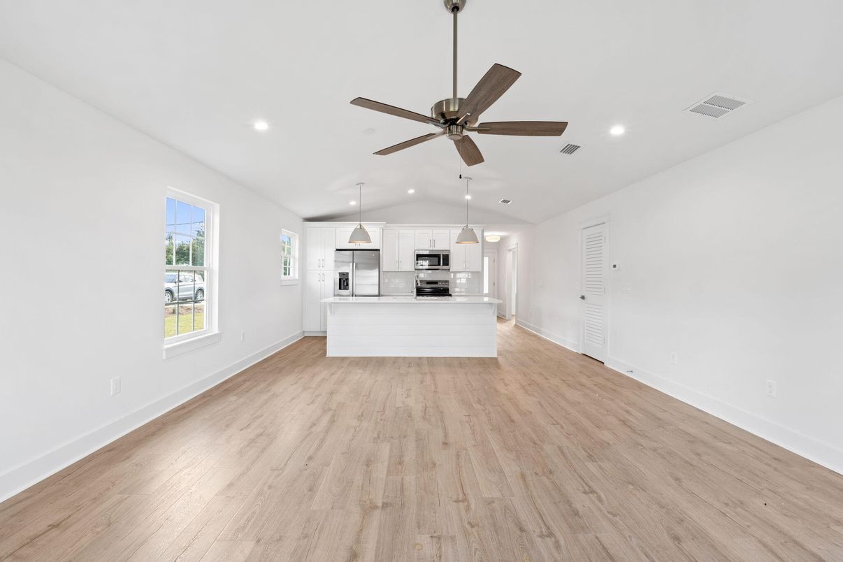 Empty room, Interior, Kitchen, Pendant Lights, Recessed Lighting, Stainless Steel Appliances, Wood Texture Flooring