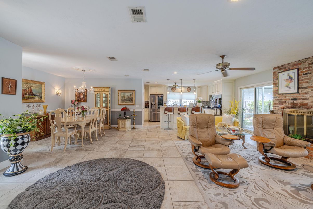 Chandelier, Dining room, Fireplace, Interior, Kitchen, Living room, Recessed Lighting, Stainless Steel Appliances, Stone Walls