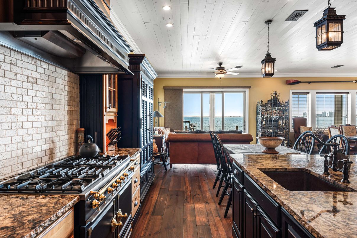 Dining room, Interior, Kitchen, Pendant Lights, Recessed Lighting, Stainless Steel Appliances, Stone Walls, Water, Wood Texture Flooring