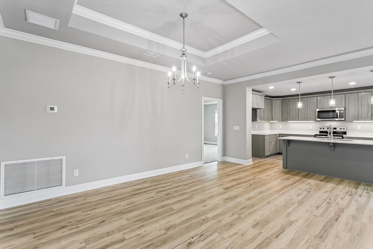 Chandelier, Empty room, Interior, Kitchen, Pendant Lights, Recessed Lighting, Stainless Steel Appliances, Wood Texture Flooring