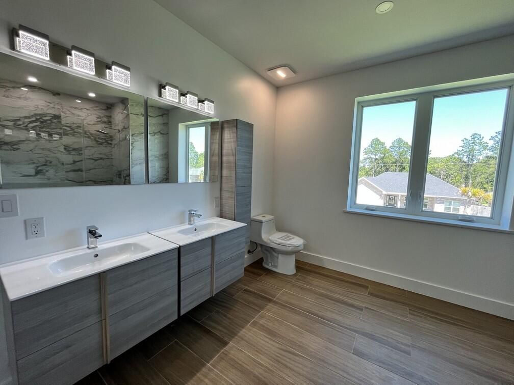 Bathroom, Dual Sink Vanities, Interior, Marble Walls, Recessed Lighting, Wood Texture Flooring