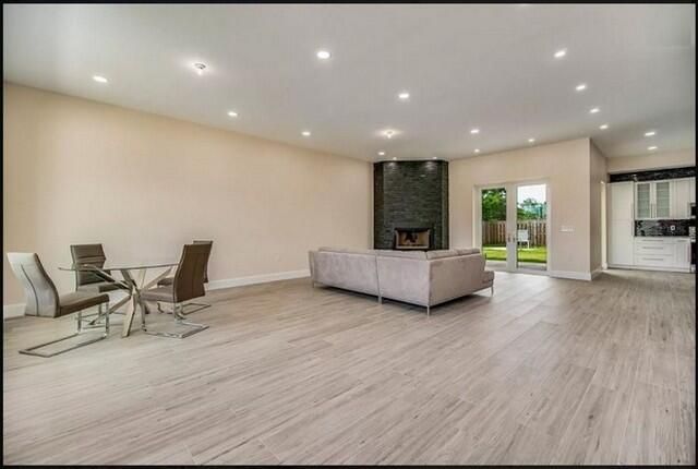 Dining room, Fireplace, Interior, Living room, Recessed Lighting, Wood Texture Flooring