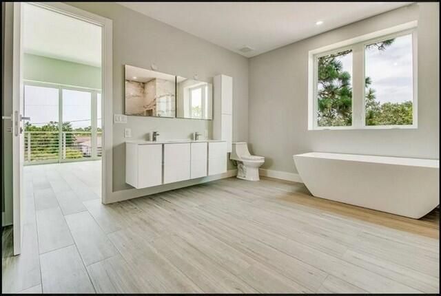 Bathroom, Dual Sink Vanities, Free Standing Baths, Interior, Recessed Lighting, Wood Texture Flooring