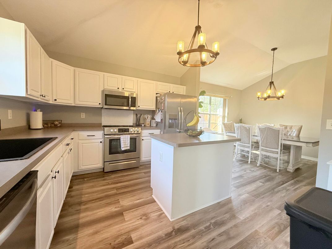 Chandelier, Dining room, Interior, Kitchen, Pendant Lights, Stainless Steel Appliances, Wood Texture Flooring
