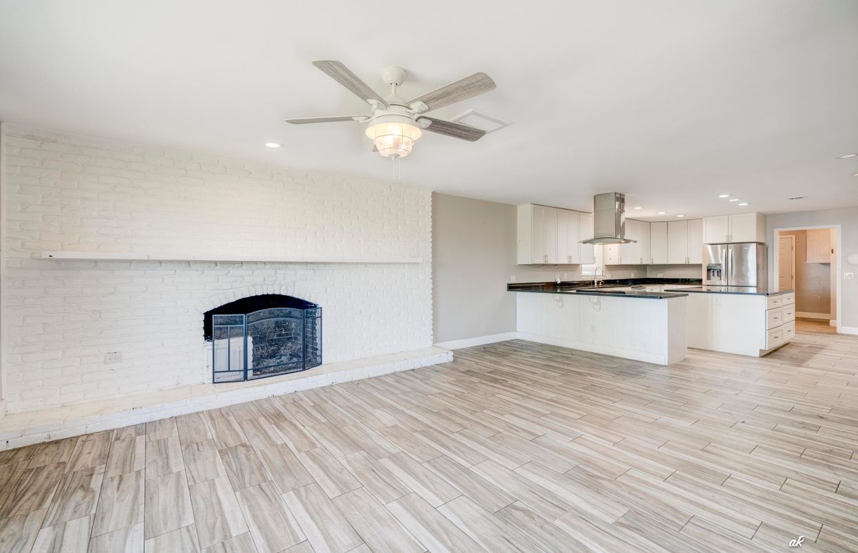 Fireplace, Interior, Kitchen, Recessed Lighting, Stainless Steel Appliances, Stone Walls, Wood Texture Flooring