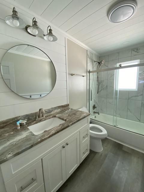 Bathroom, Dual Sink Vanities, Glass Shower, Interior, Marble Walls, Wood Texture Flooring