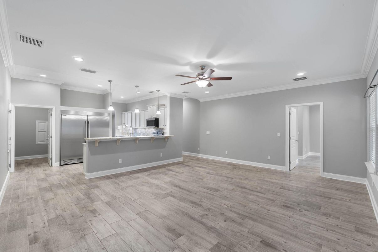 Empty room, Interior, Kitchen, Pendant Lights, Recessed Lighting, Stainless Steel Appliances, Wood Texture Flooring