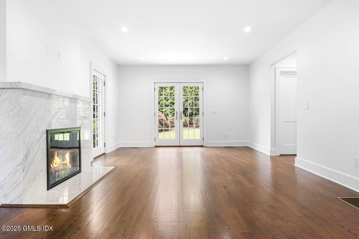 Empty room, Fireplace, Interior, Marble Walls, Recessed Lighting, Wood Texture Flooring