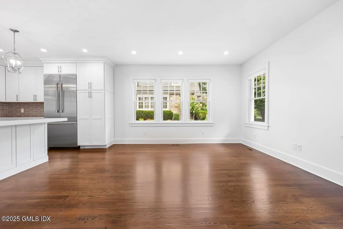 Empty room, Interior, Kitchen, Pendant Lights, Recessed Lighting, Stainless Steel Appliances, Wood Texture Flooring