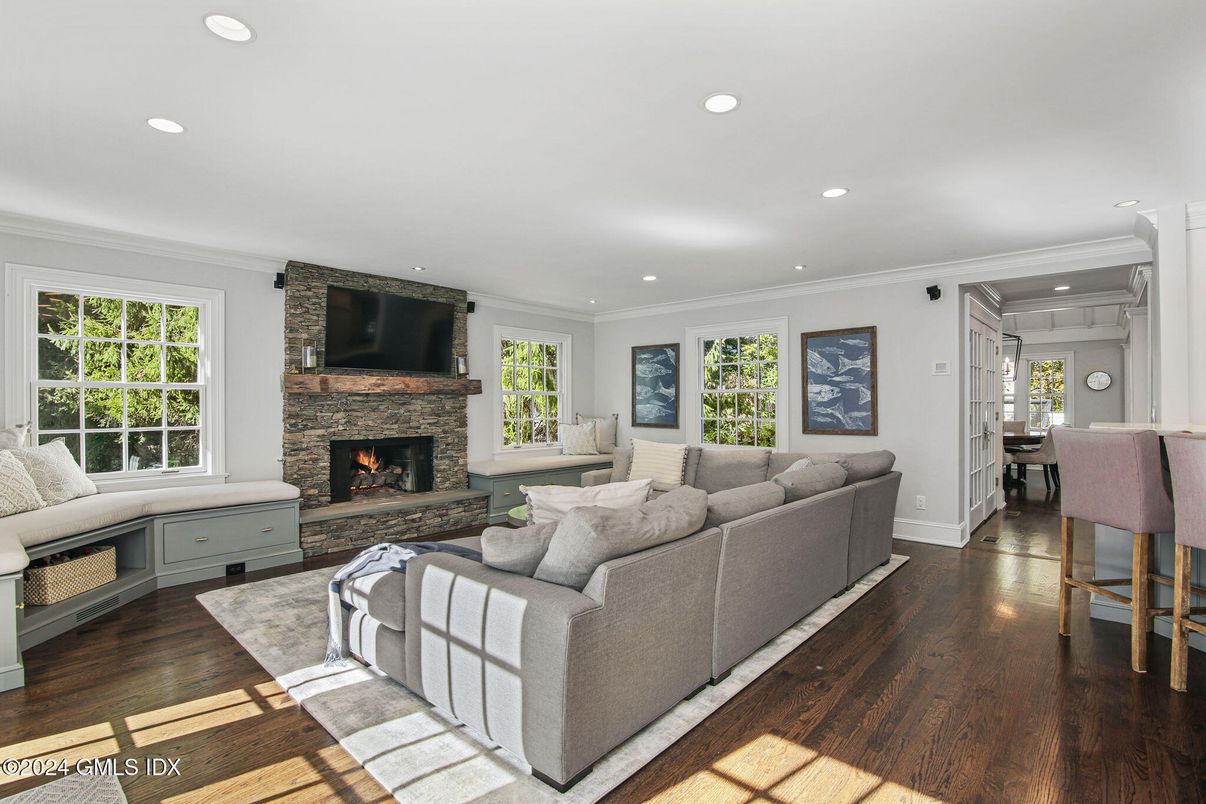 Dining room, Fireplace, Interior, Living room, Recessed Lighting, Stone Walls, Wood Texture Flooring