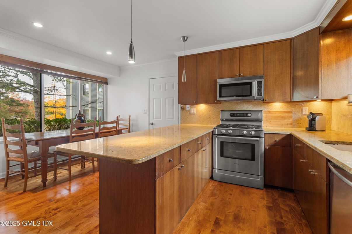 Dining room, Interior, Kitchen, Pendant Lights, Recessed Lighting, Stainless Steel Appliances, Wood Texture Flooring